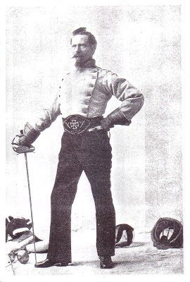 an old black and white photo of a man in uniform with his hands on his hips