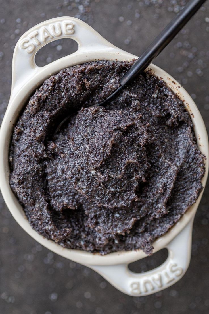 a cup filled with chocolate cake batter and a black spoon