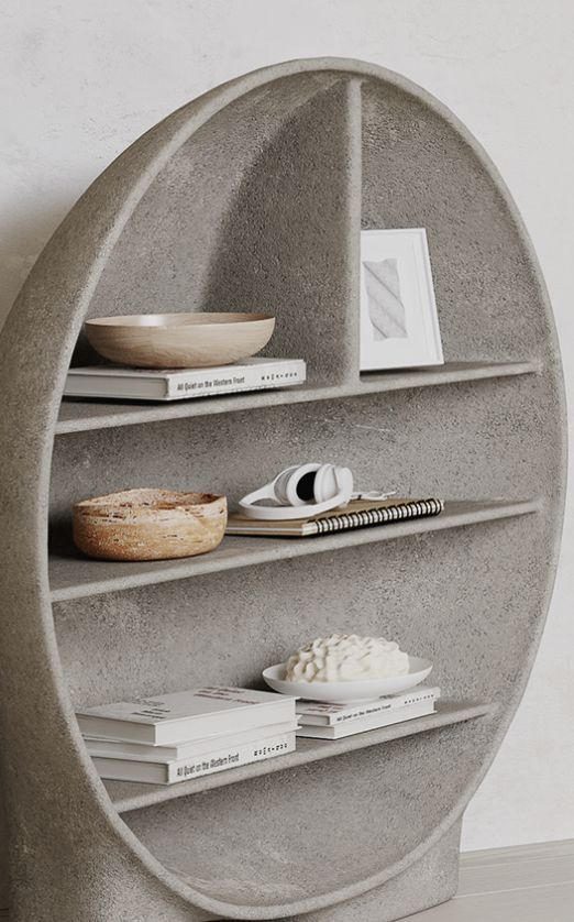 a concrete shelf with books and plates on it