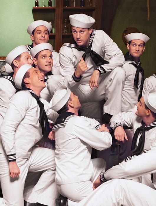 a group of men in sailor suits posing for a photo