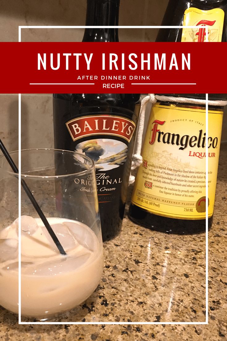 a glass filled with liquid sitting on top of a counter next to bottles and an empty bottle