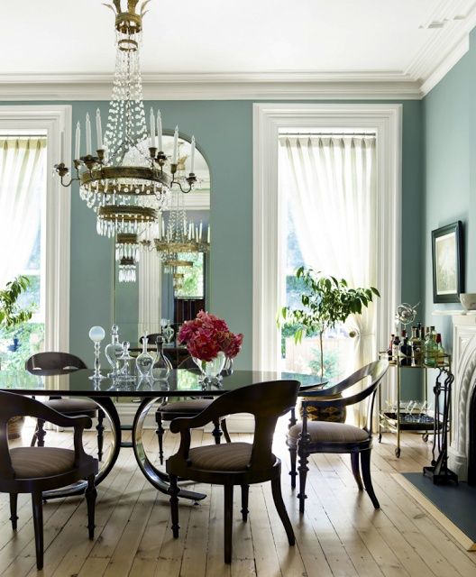 a dining room table with chairs and a chandelier