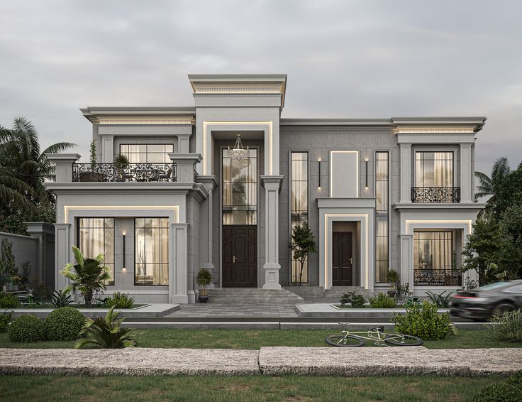 a two story house with lots of windows and balconies on the second floor