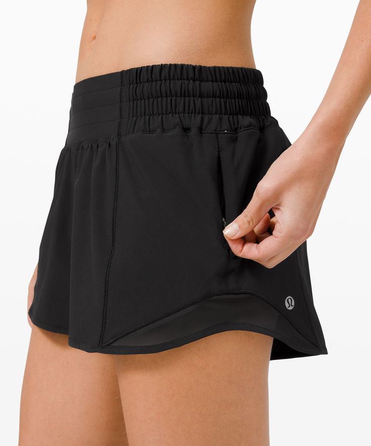 a woman in black shorts with her hand on the side of her pants pocketed