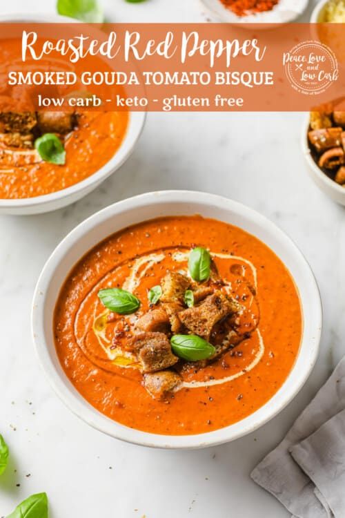 two bowls of roasted red pepper and smoked gourmet tomato biscuit soup with basil garnish