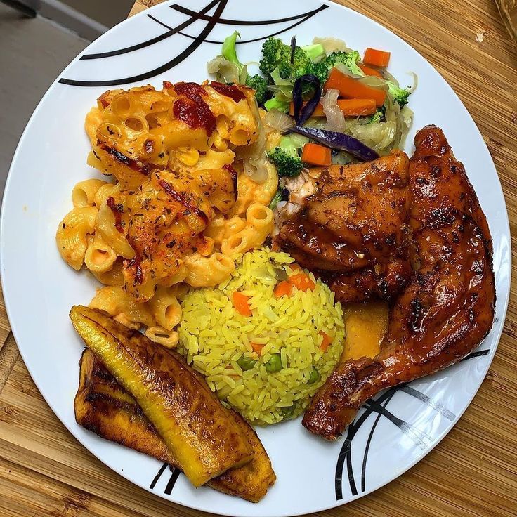 a white plate topped with meat, pasta and veggies