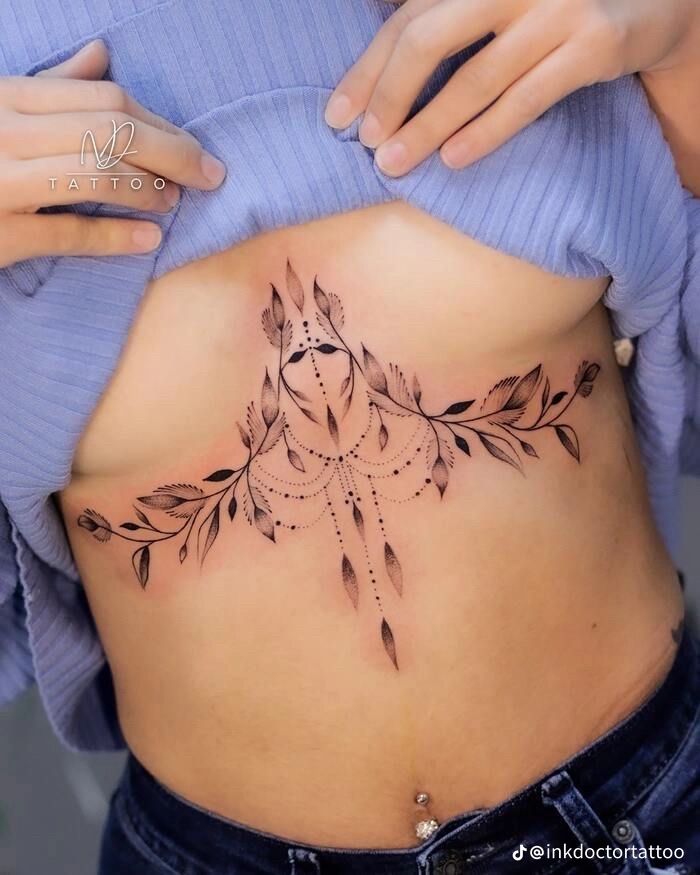 a woman with a tattoo on her stomach