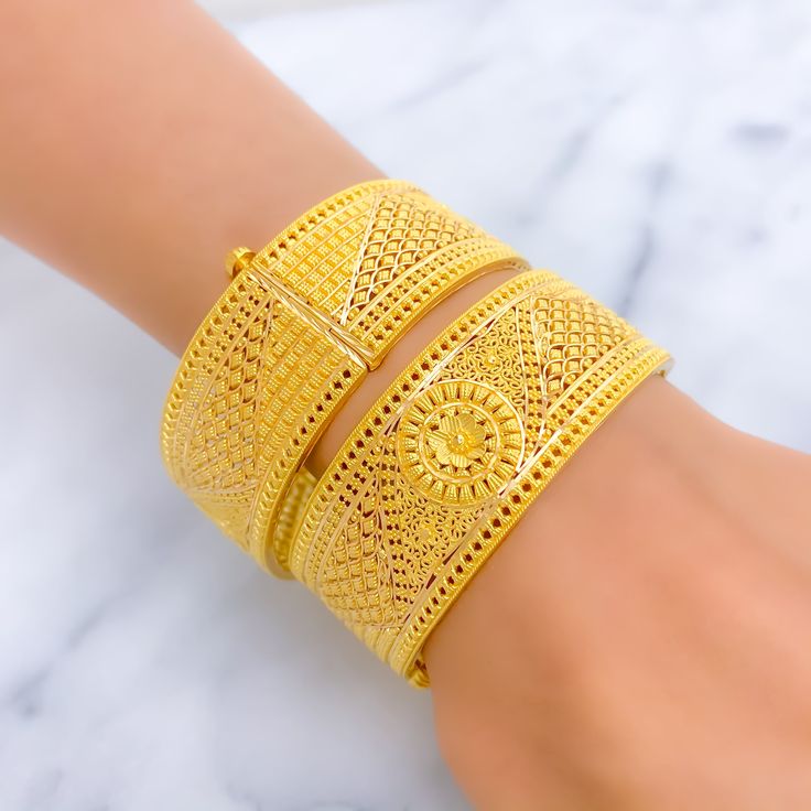 This opulent pair of bangles is forged from 22k gold, weighing 77.6 grams, and polished to a radiant yellow gold finish. Each bangle has a size of 2.6 inches with an opening diameter of 2.35 inches, ensuring a comfortable fit. Featuring a royal mesh floral design, these bangles combine luxury with intricate craftsmanship. They are openable, incorporating a screw and hinge mechanism for secure and convenient wear. Ideal for adding a touch of regal elegance to any ensemble, these bangles are perfe Yellow Bangle Bracelet With Intricate Design, Yellow Bangle Bracelets With Intricate Design, Yellow Bangle With Intricate Design For Festivals, Festive Yellow Bangle With Intricate Design, Yellow Gold Bangle Bracelet With Intricate Design, Gold-plated Yellow Bangle With Intricate Design, Yellow Gold Plated Bangle With Intricate Design, Yellow 22k Gold Bangle With Intricate Design, Formal Yellow 22k Gold Bangle