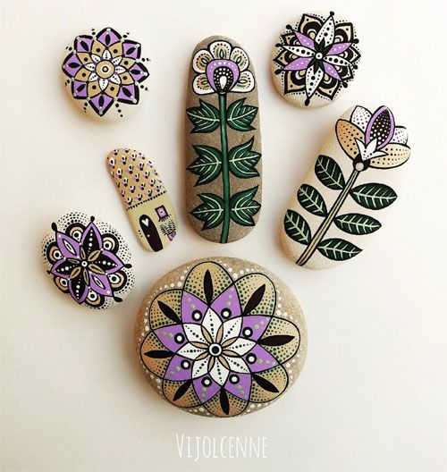 painted rocks with flowers and leaves on them are arranged in the shape of a flower