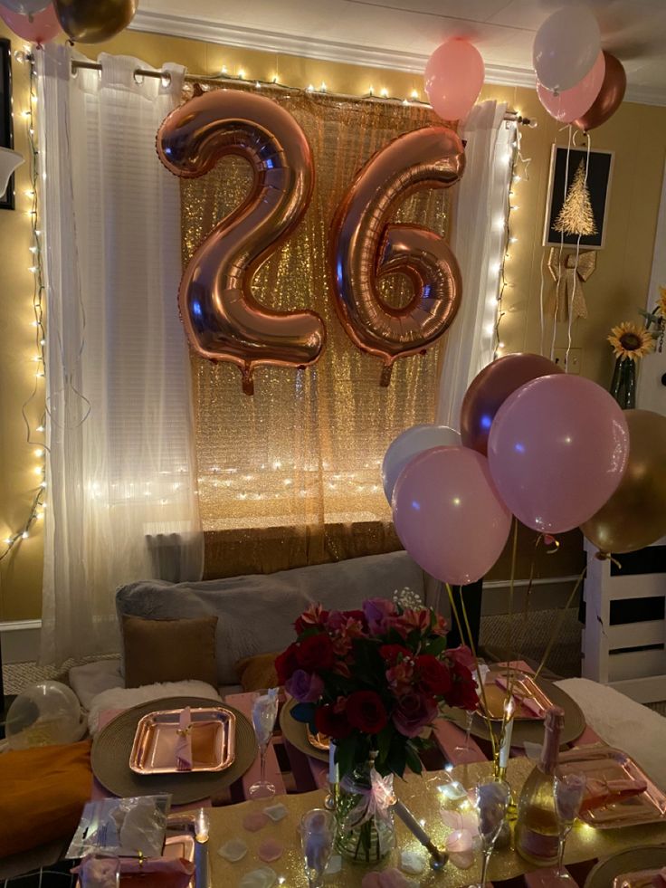 the table is set with balloons and plates