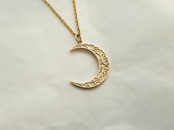 mens womens crescent moon necklace pendant made in 14k or 18k solid goldthe delicate patterns that make it more attractive are on the crescent moon pendant.model wears a 14k 1.7mm 50cm chain.free shipping on all orders via fedex!14k gold mens womens crescent moon pendant necklace weightpendant only 2.46g (±7%)with 1.4mm 42cm chain 5.11g (±7%)with 1.7mm 42cm chain 6.26g (±7%)with 2.2mm 42cm chain 8.21g (±7%)18k gold mens womens crescent moon pendant necklace weightpendant only 2.93g (±7%)with 1.4 Crescent Moon Charm Necklace In 14k Gold, Crescent 14k Gold Engraved Necklace, Elegant Engraved Moon-shaped Necklace, Elegant Moon-shaped Engraved Necklace, Delicate Crescent Moon Phase Jewelry, Elegant Engraved Moon Shaped Necklace, Elegant Engraved Moon Necklace, Elegant Crescent Engraved Necklace, Elegant Engraved Crescent Necklace