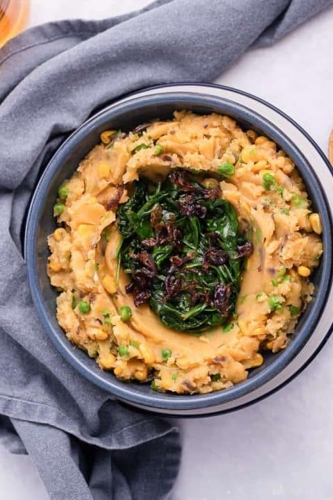 potatoes, peas, and corn - kenyan iro in a bowl with a spoon