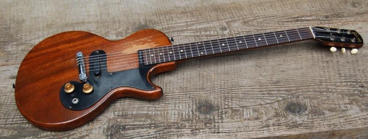 an electric guitar sitting on top of a wooden table