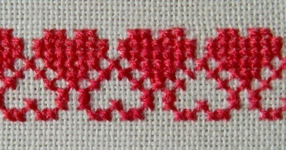 a close up view of some red stitching