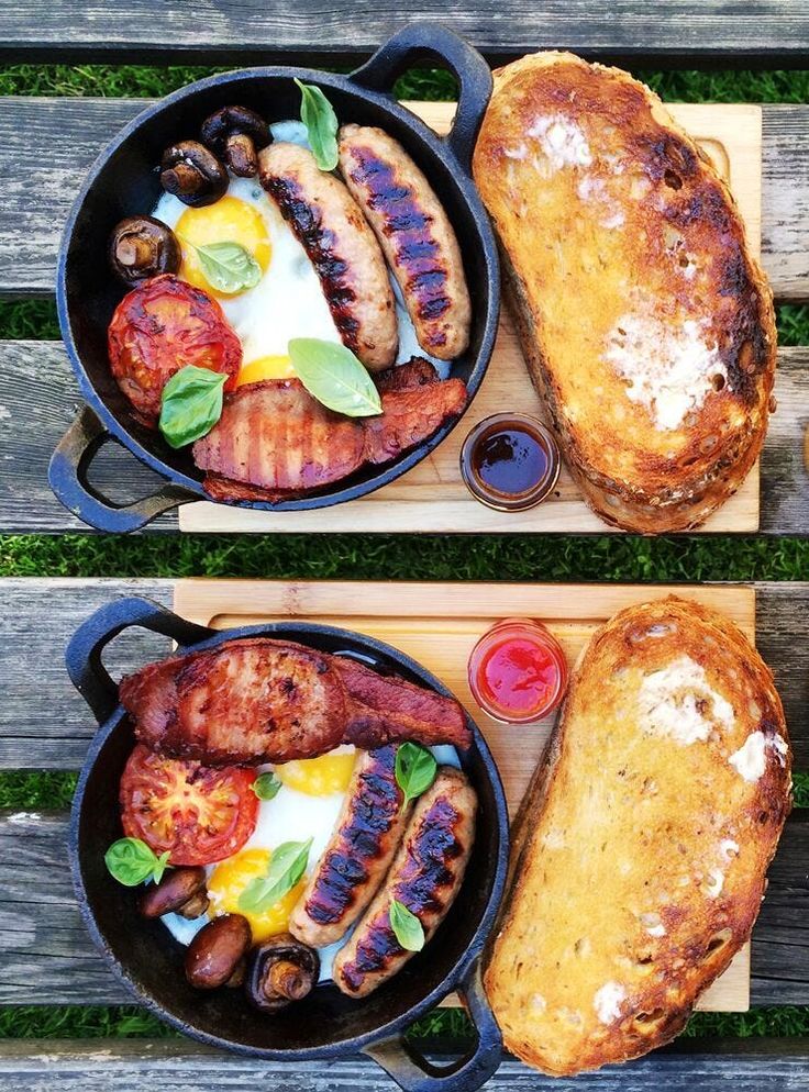 two pans filled with food sitting on top of a wooden table next to each other