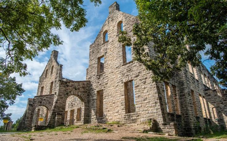 an old stone church sitting on top of a hill