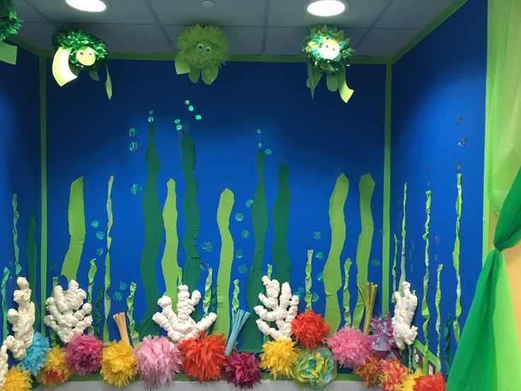 an aquarium themed classroom display with seaweed, corals and other marine life on the wall