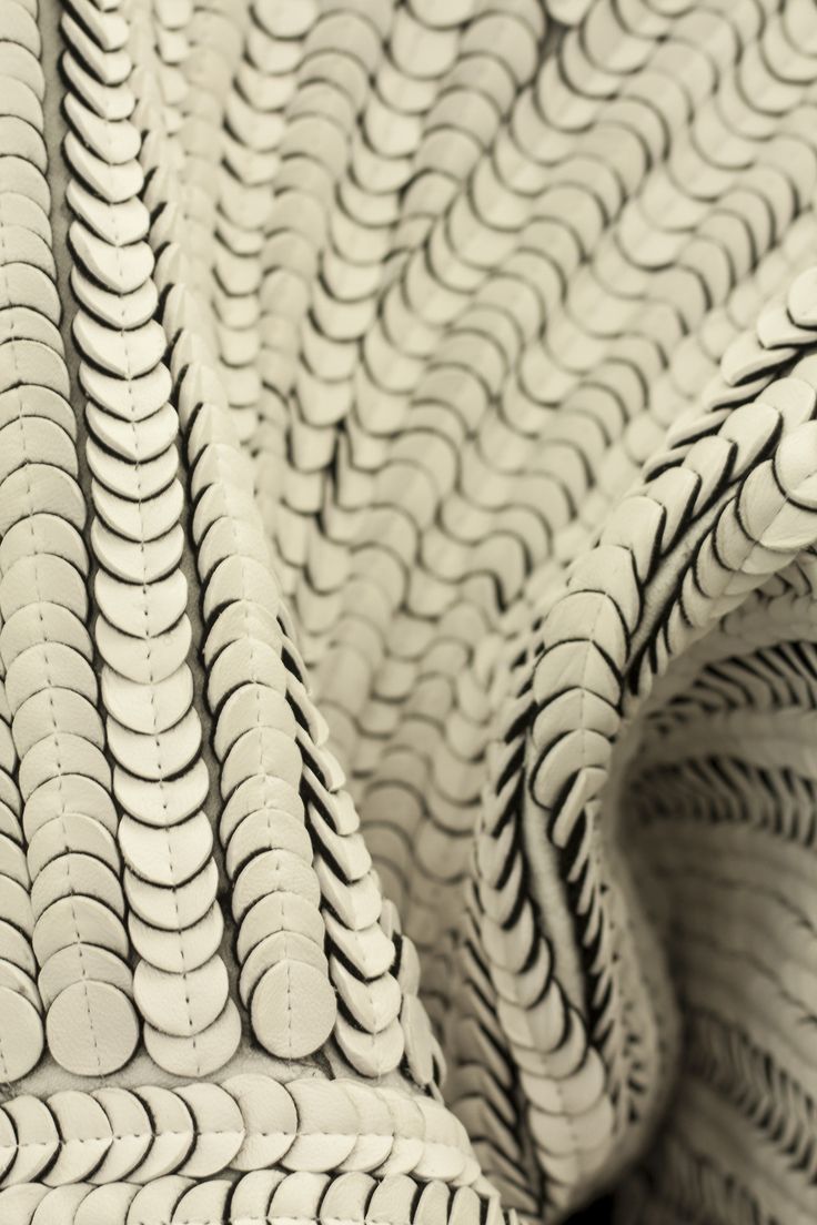 black and white photograph of an abstract pattern made up of many circular pieces of plastic