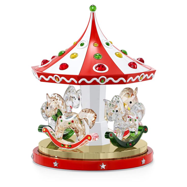 a merry go round carousel with two elephants on it's sides and an umbrella