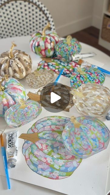 the table is covered with many decorative items and supplies for making pumpkins or cookies