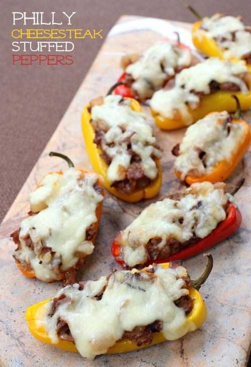 stuffed bell peppers with cheese and meat are on a cutting board, ready to be eaten