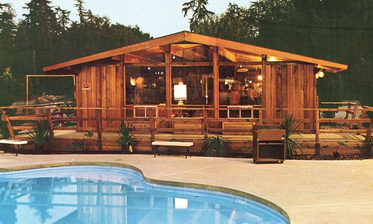 a wooden cabin sitting next to a swimming pool