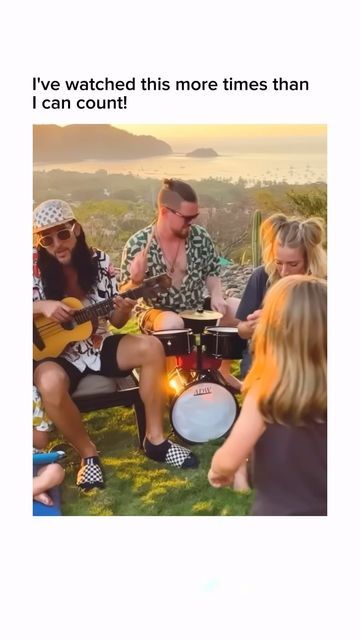 a group of people that are sitting in the grass