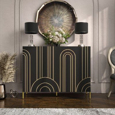 a black and gold sideboard with two lamps on it next to a white rug