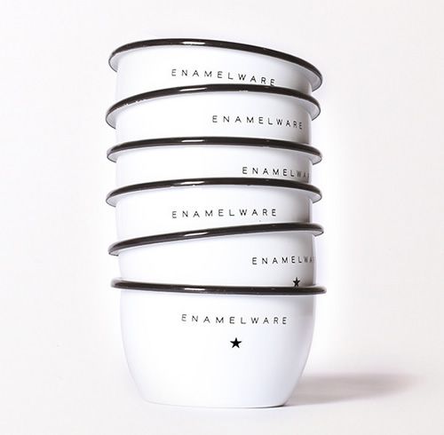 four white bowls stacked on top of each other with black rims and words written in them