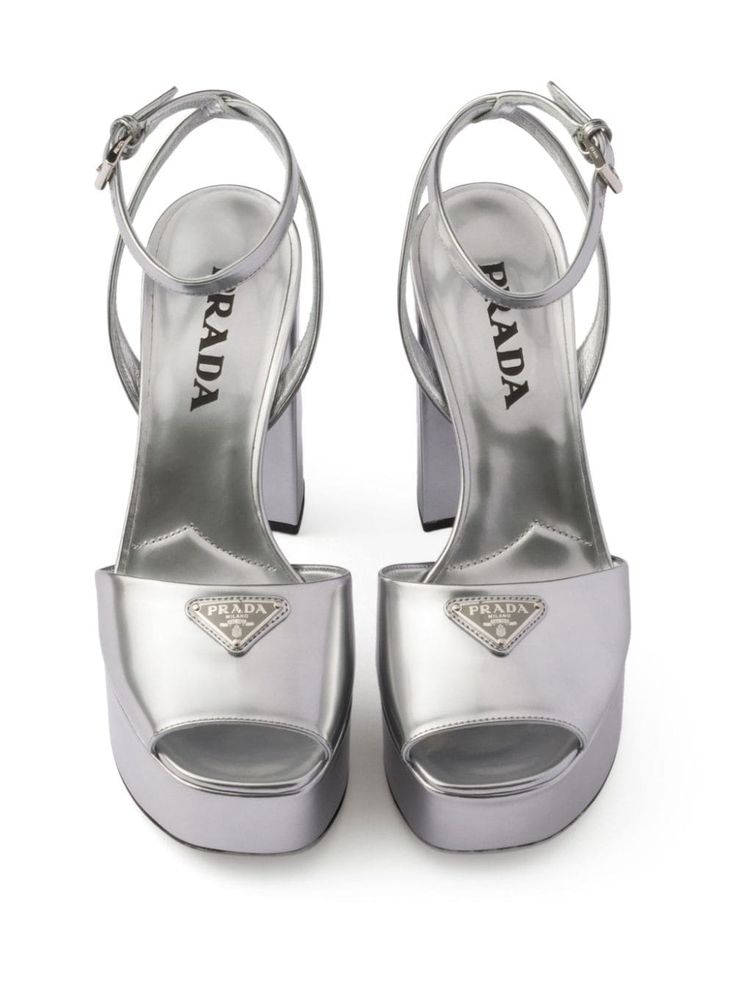 Find PRADA 115mm Leather Platform Sandals on Editorialist. silver-tone leather metallic finish enamel triangle logo silver-tone hardware square open toe buckle-fastening ankle strap 115mm block heel branded leather insole platform sole Luxury Silver Heels With Buckle Closure, Luxury Heels With Silver-tone Hardware For Formal Occasions, Luxury Silver-tone Heels For Formal Occasions, Luxury Evening Heels With Silver-tone Hardware, Luxury Silver-tone Heels For Evening, Silver Luxury Sandals With Heel Strap, Luxury Patent Leather Sandals With Square Toe, Modern Silver Heels With Buckle Closure, Luxury Metallic Open Heel Shoes