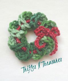 two crocheted christmas wreaths sitting on top of each other