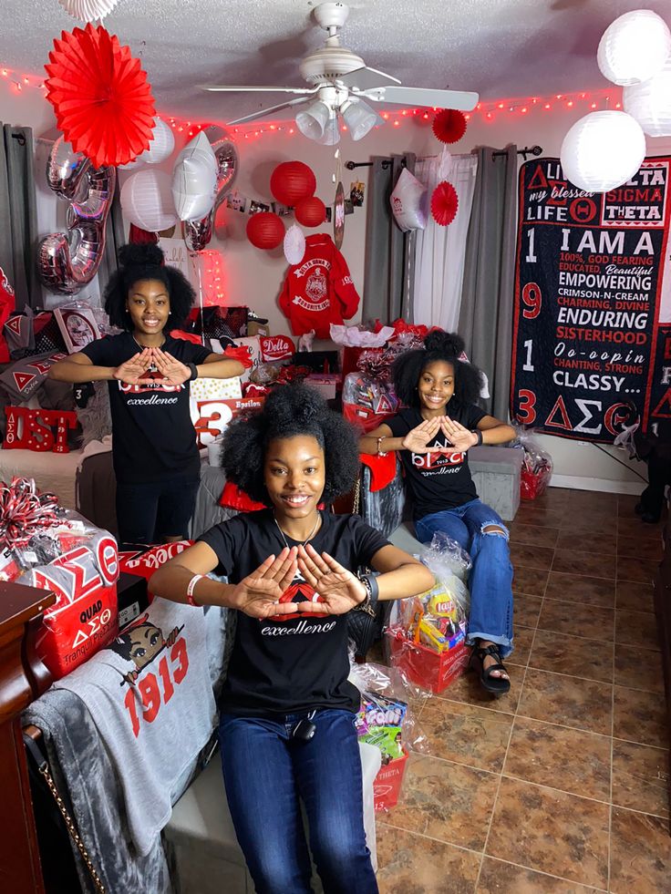 a group of women standing in front of a room filled with red and white decorations