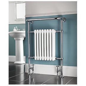 a white radiator in a bathroom next to a sink