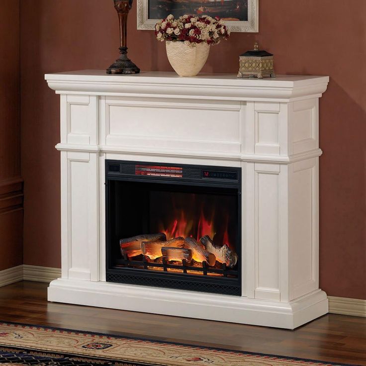 a white fireplace with an electric fire in it