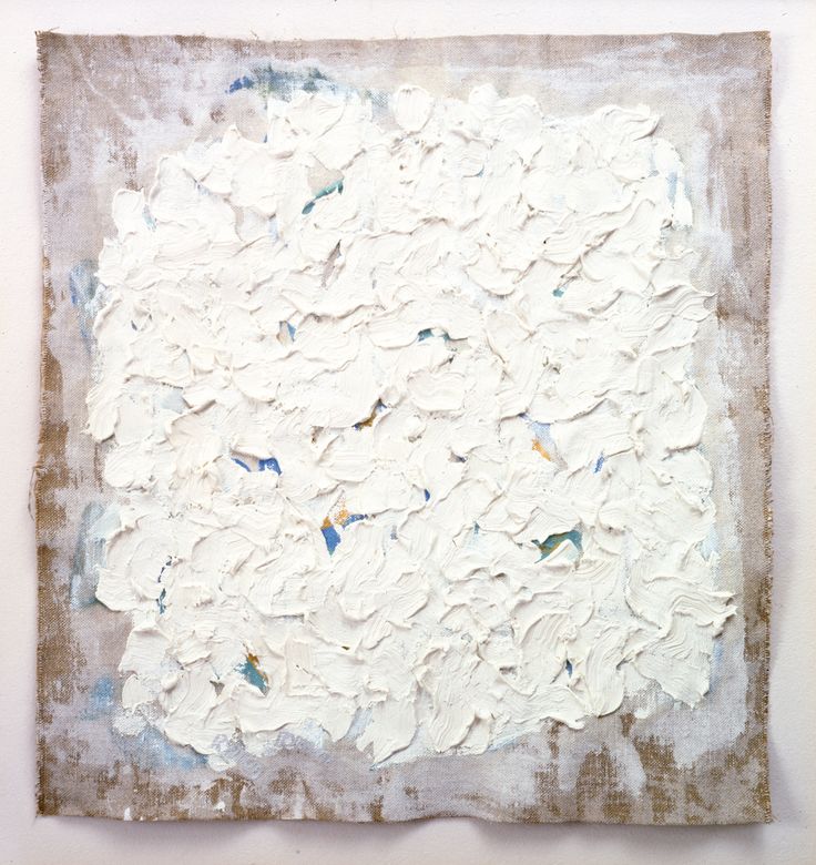 an abstract painting with white paint and brown paper