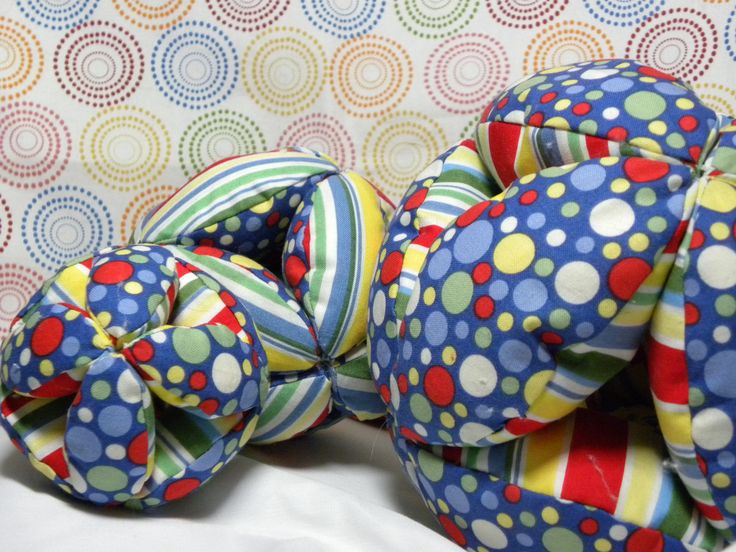 two balls are stacked on top of each other in front of a colorful wallpaper