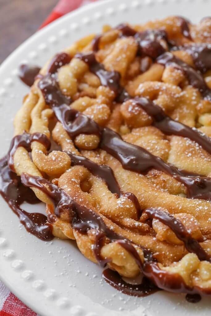 a white plate topped with cookies covered in chocolate sauce and drizzled on top