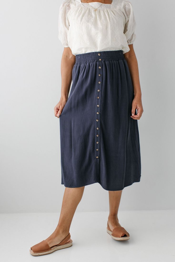 Start your day in style with the 'Greta' Skirt! This midi length, linen-blend skirt is light and airy for spring and summer and features button-down detailing for a fun touch. Pair the 'Greta' with all your favorite tops for Sunday morning or a day at the farmer's market! 30% Linen 70% Rayon Hand Wash Cold Hang to Dry Low Iron if Needed Do Not Dry Clean Fully Lined Model in Ochre Height 5'5" | Wearing Size Small Wearing 'Shalom' Geometric Print Top in Tan & 'Greta' Linen Blend Midi Skirt in Ochre Model in Ochre & Dark Blue Height 5'8" | Wearing Size 1X Wearing 'Sybil' Embroidered Square Neck Top & 'Greta' Linen Blend Midi Skirt in Ochre Wearing 'Shalom' Geometric Print Top in Tan & 'Greta' Linen Blend Midi Skirt in Dark Blue Model in Dark Blue & Black Height 5'9" | Wearing Size Small Weari Spring Midi Bottoms With Button Closure, Spring Vacation Button-up Bottoms, Knee-length Summer Bottoms With Buttons, Casual Midi Skirt With Button Closure For Day Out, Midi Length Bottoms With Button Closure For Day Out, Casual Midi Bottoms With Button Closure For Day Out, Spring Relaxed Skirt With Button Closure, Spring Long Skirt With Buttons, Cotton Midi Bottoms For Vacation