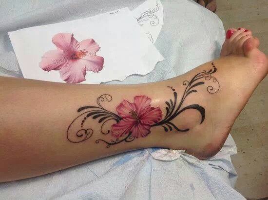 a woman's foot with flowers on it