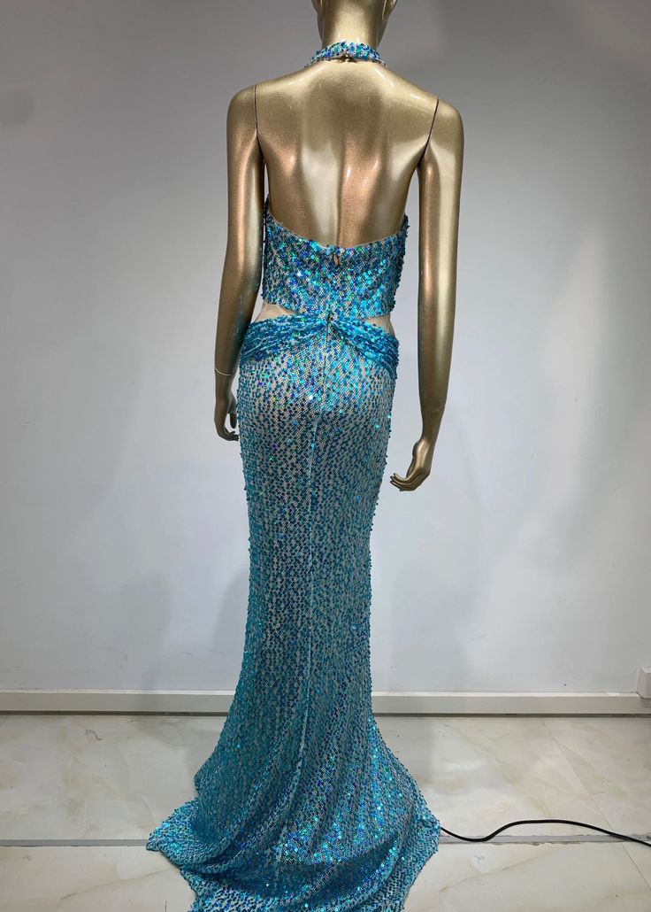 The ALISHA Sequined Maxi Dress is a stunning evening dress crafted with a plunging neck and a halter design. Its floor length, mermaid hem and backless feature ensures a dramatic and alluring look. With shimmering sequins in a beautiful sky blue, this dress is perfect for any special occasion. Fabric: Non-Stretch Material: Polyester Fiber *Actual color may vary slightly due to photo lighting and display screen color differences. Blue Party Gown With Back Opening, Mermaid Dress With Back Opening For Prom, Backless Gala Gown, Blue Gown With Back Opening For Party, Fishtail Maxi Dress For Gala And Prom Season, Backless Gown With Sweep Train For Gala, Fishtail Maxi Dress With Fitted Bodice For Party, Floor-length Gown With Back Opening For Party, Blue Evening Dress With Sweep Train For Night Out