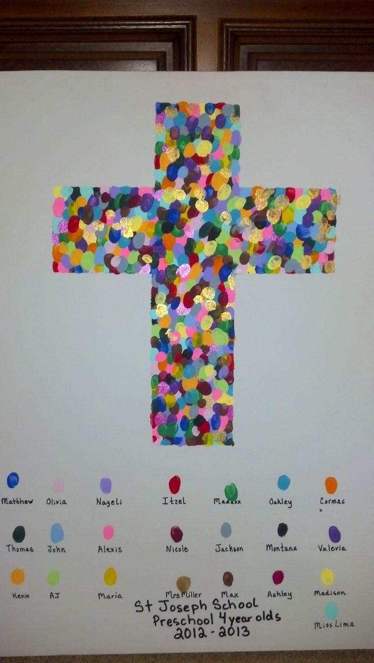 a cross made out of confetti on a bulletin board