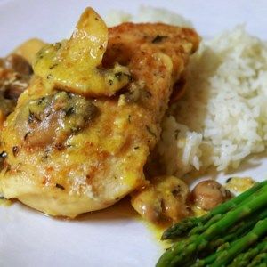 a white plate topped with chicken, rice and asparagus