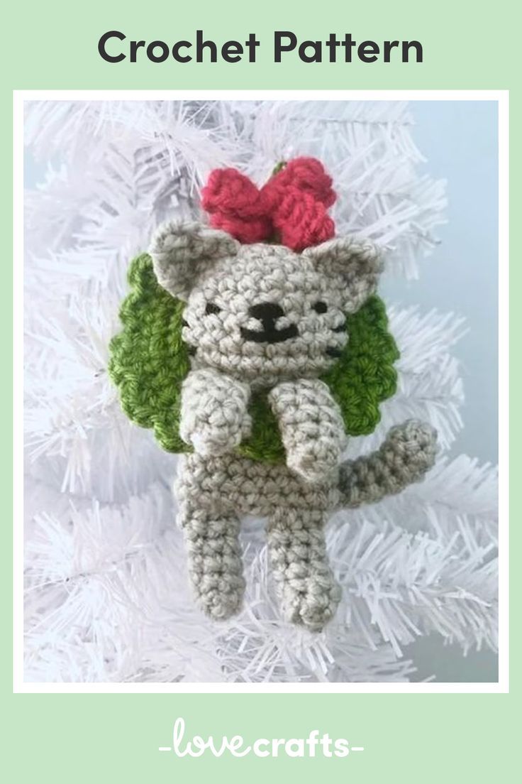 a crocheted bear ornament hanging from a christmas tree