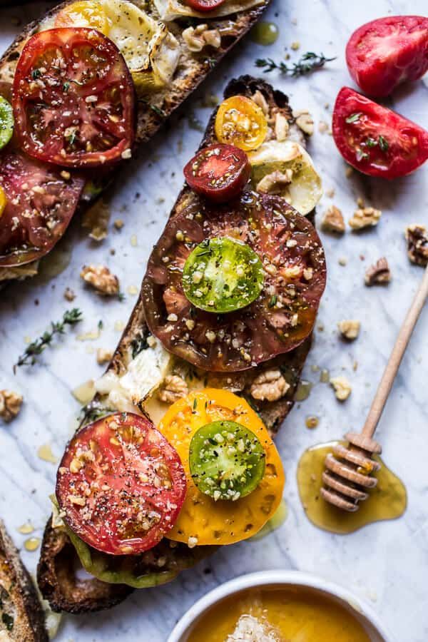 toast with tomatoes, cheese and pesto on it