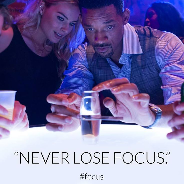 three people are looking at their cell phones in front of a table with drinks on it