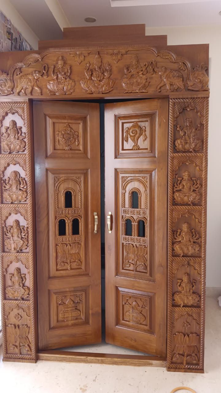 an ornate wooden door with carvings on it