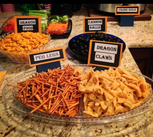 a variety of snacks are displayed on a counter top with labels reading dragon claws, pecans, and blueberries