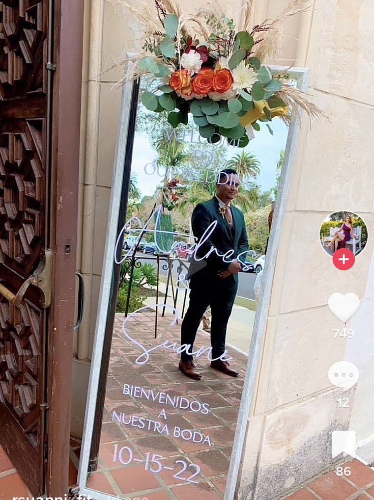 a man standing in front of a door with a sign on it that says bivenndos neesta roda