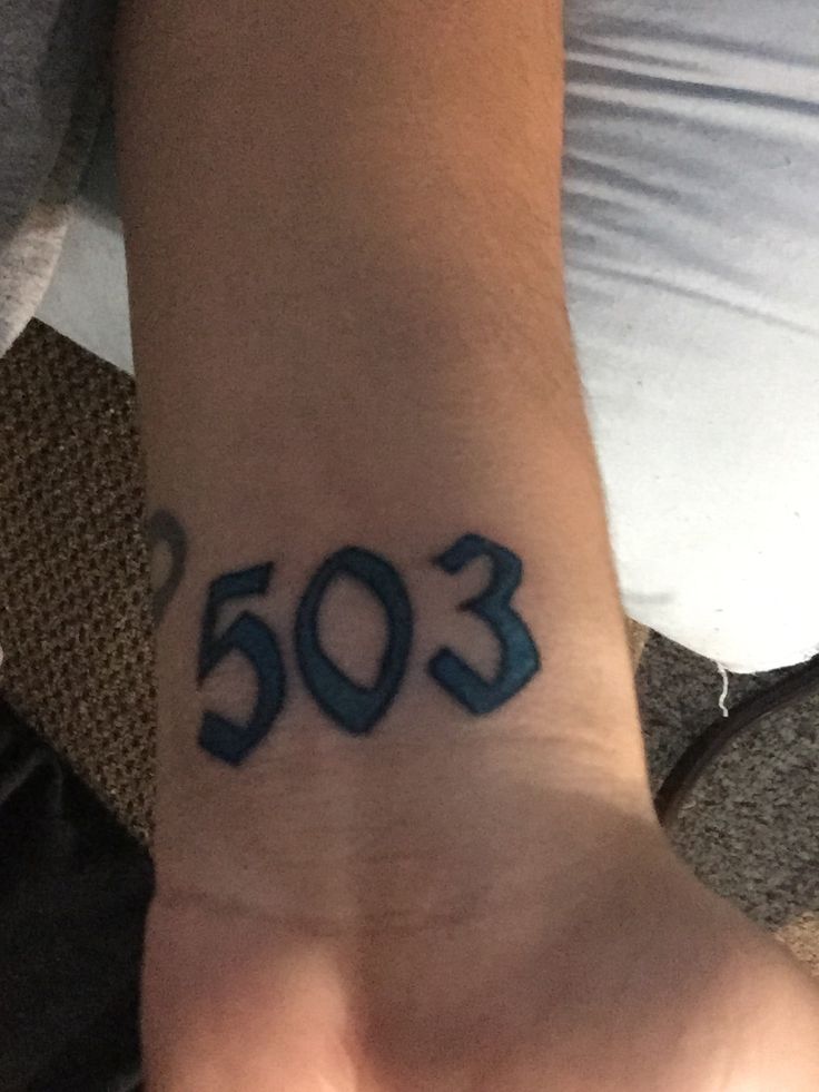 someone has a tattoo on their wrist that says'503'in blue ink