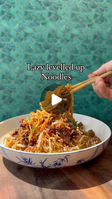 someone is eating noodles with chopsticks in a bowl